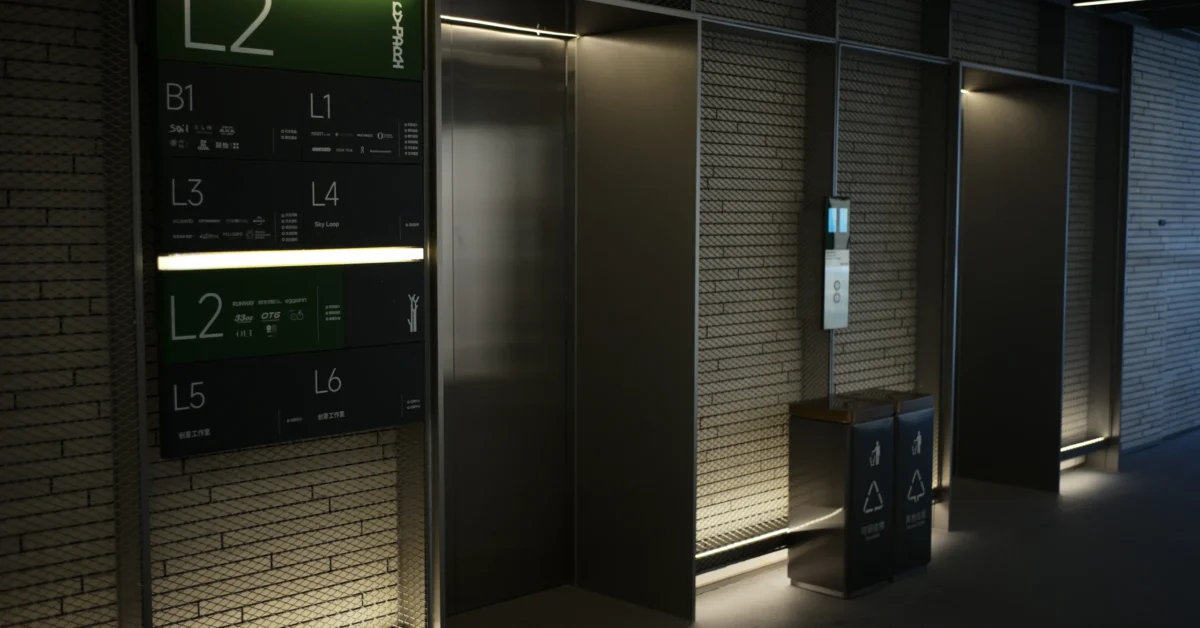 Modern office lift lobby with a floor directory sign